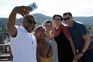 people taking a selfie with mountains in the background