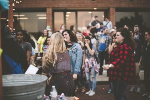 college kids gathering with gray tub