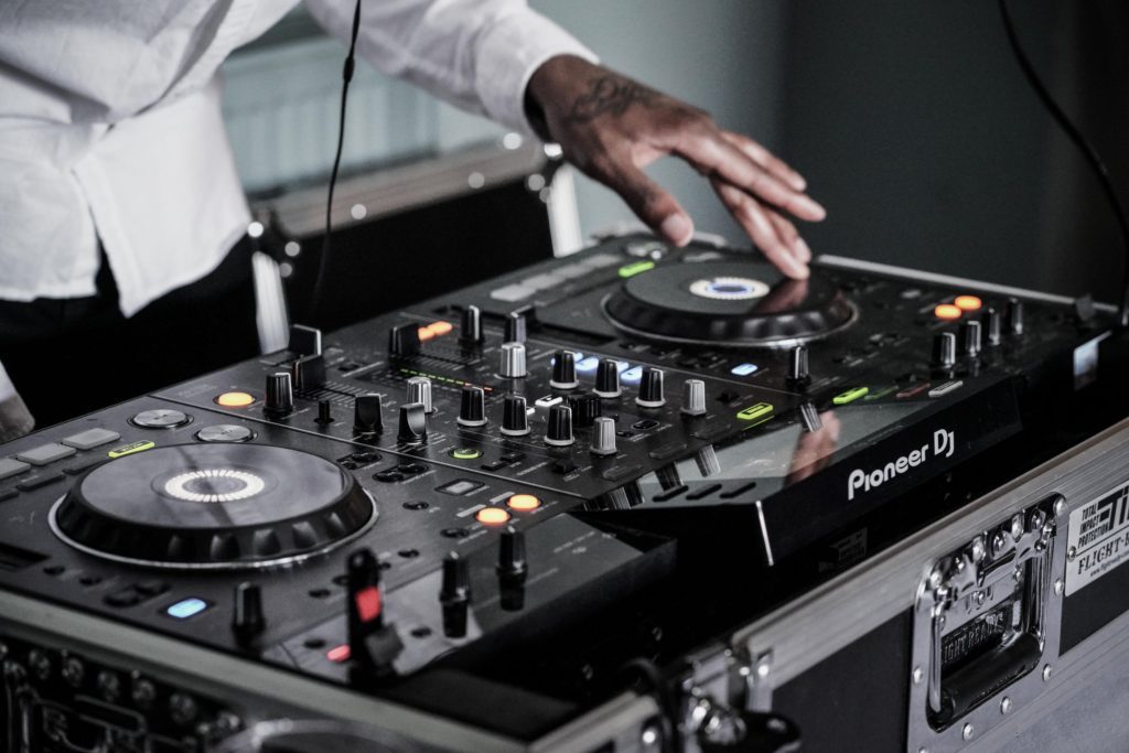 dj playing music on pioneer dj controller